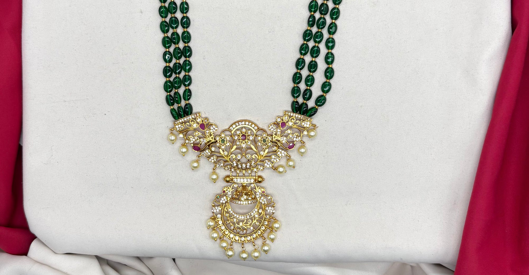 Elegant Green beads paired with a traditional, gold-finished pendant Necklace