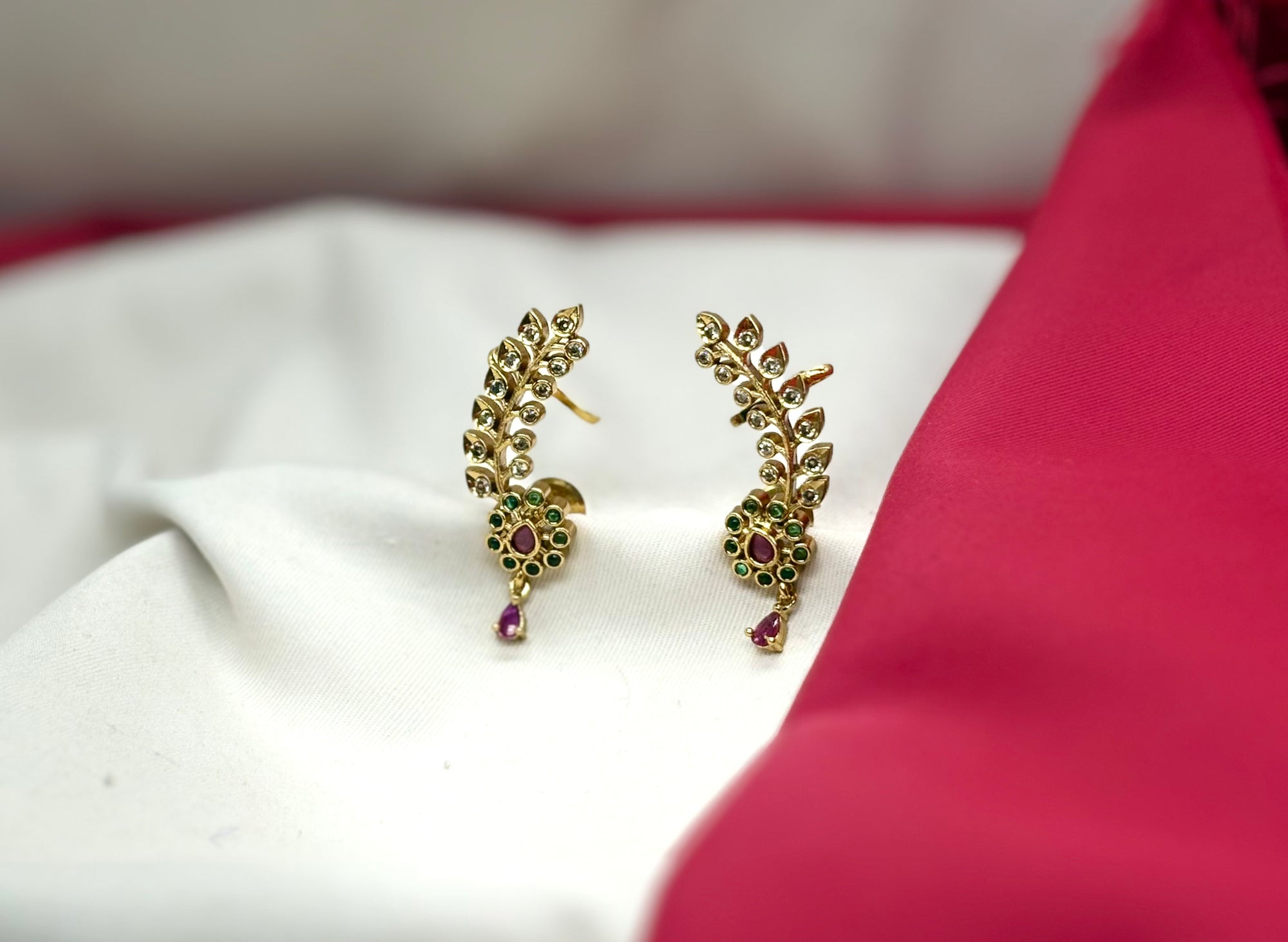 Matte finishing leaf design American diamonds with green stones earrings