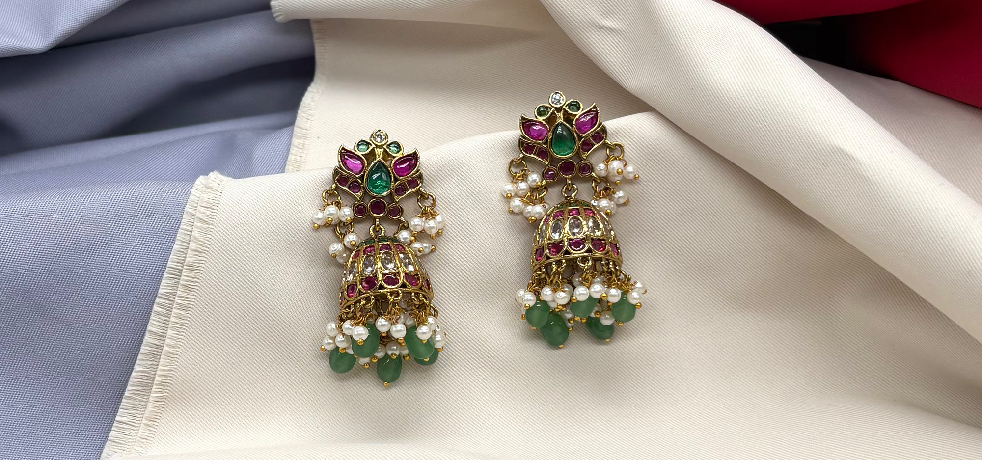 Jhumka emerald Kempu stones with pearl and green bead embellishment earrings