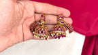 Matte finishing peacock-inspired pink Gemstones and pearl drops Jhumka’s