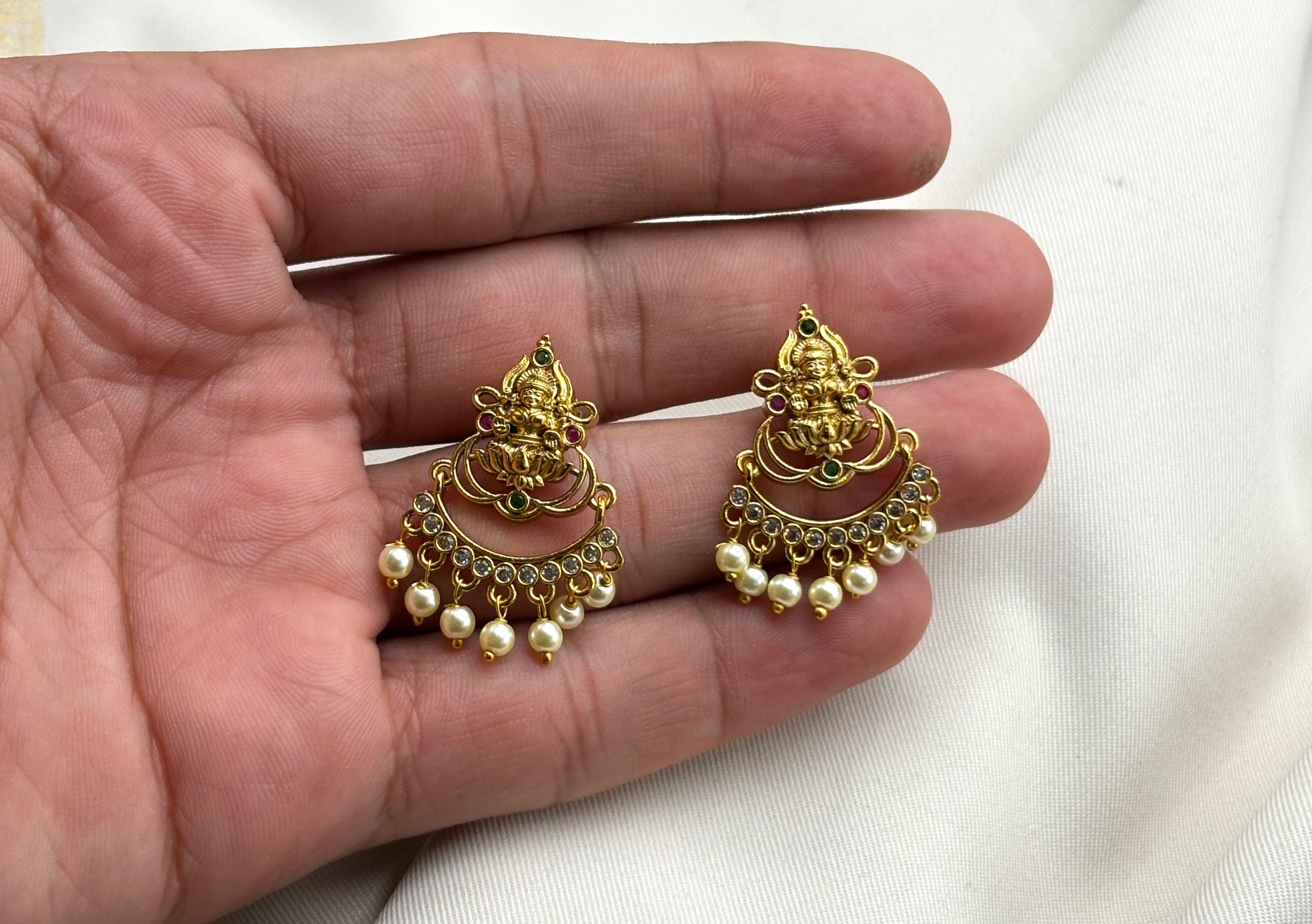 Matte finishing lord Lakshmi beautifully added white pearls Earring