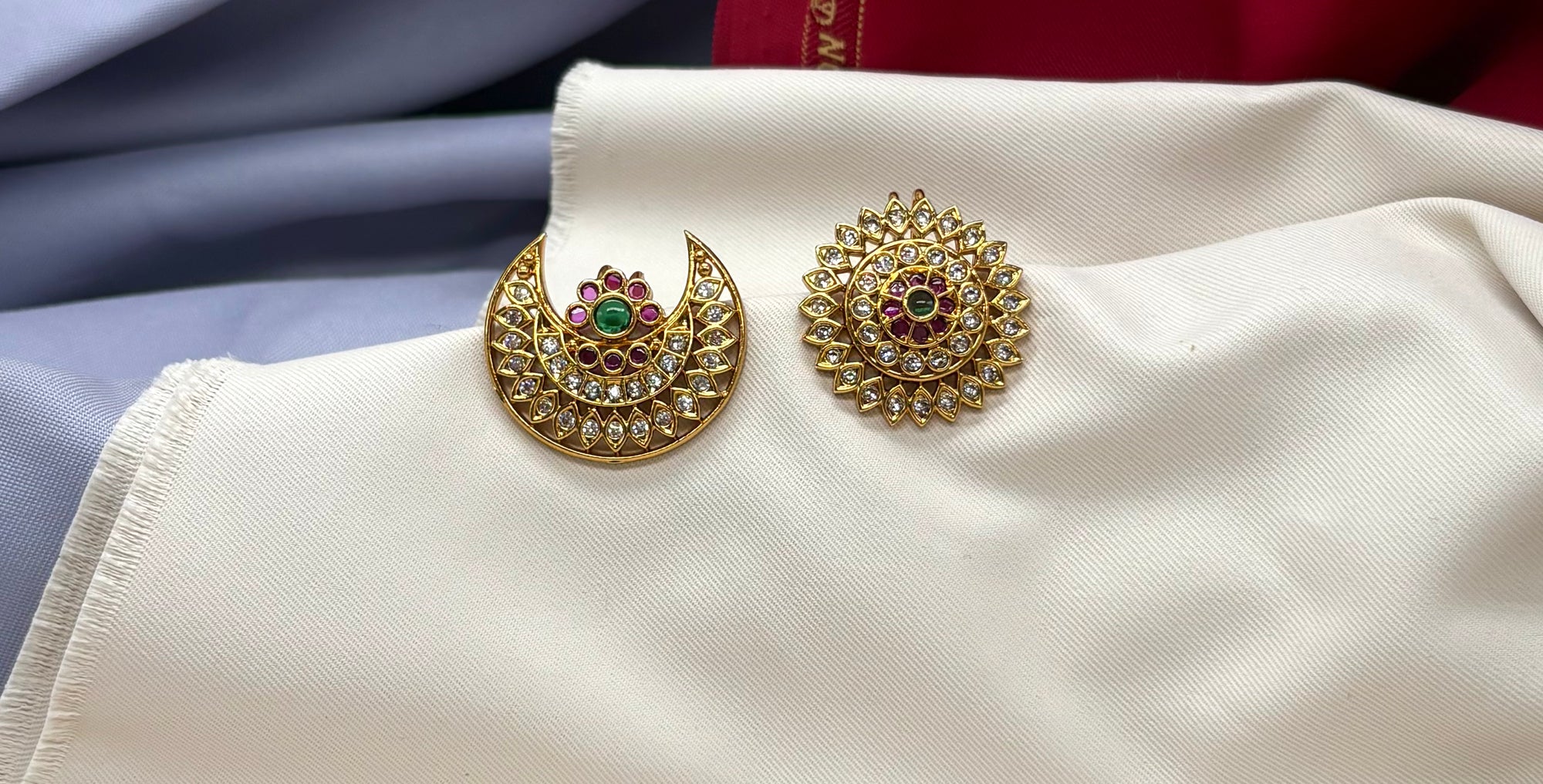 gold-plated sun and moon (Surya Chandra) featuring red and green Kemp stones.