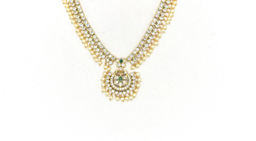 Matte finishing white stones with pearls and central green stone short Necklace