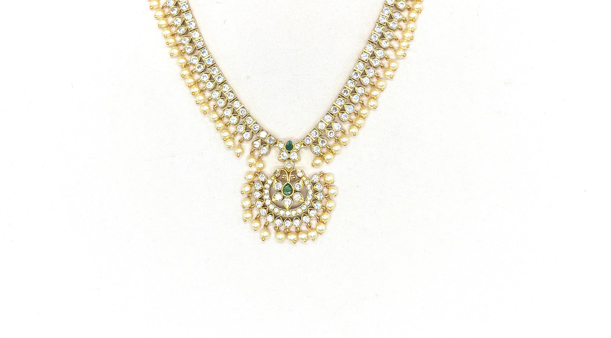 Matte finishing white stones with pearls and central green stone short Necklace