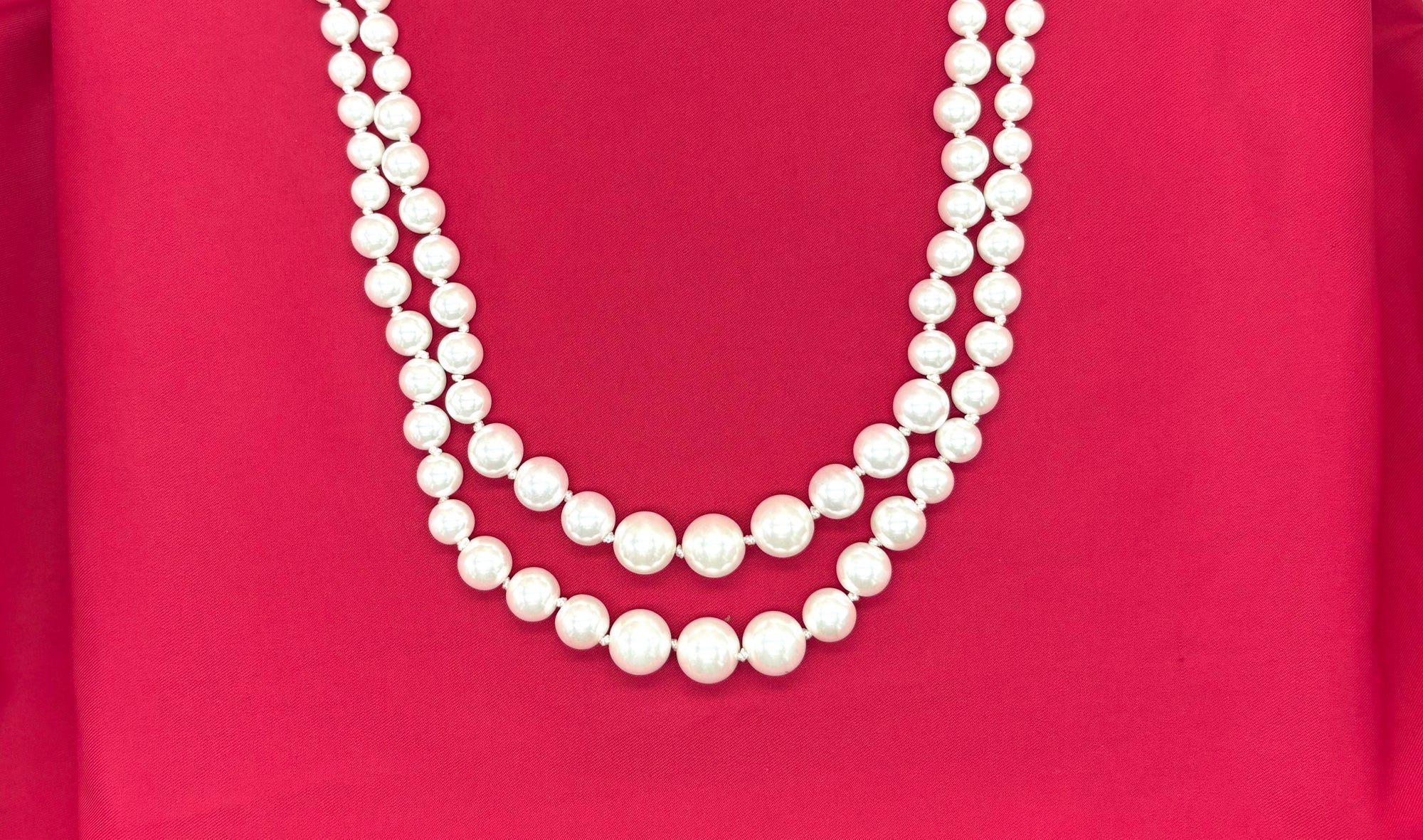 white double-layered pearl mala with a silver adjustable drawstring closure