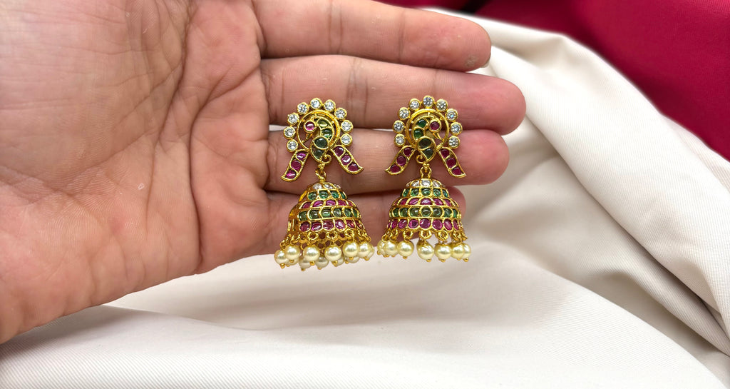 Kempu jhumka earrings featuring peacock motifs,dangling pearl beads Earrings
