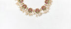 Beautifully designed with Lotus flowers and Guttapusalu clustered pearls Short Haram