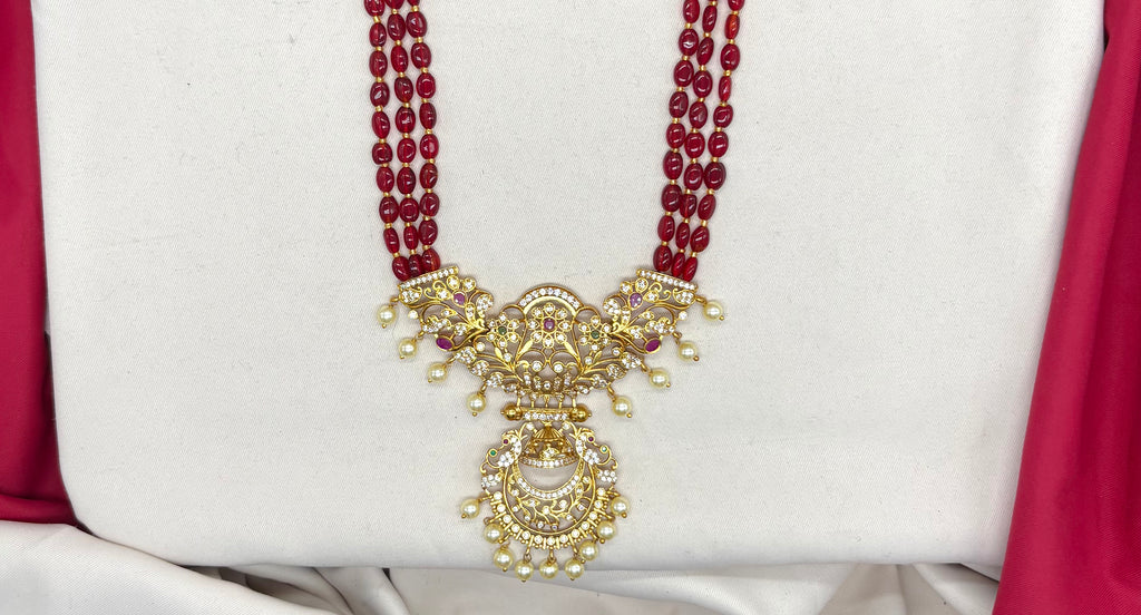 Elegant Red beads paired with a traditional, gold-finished pendant Necklace