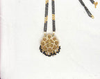 Lakshmi Devi pendant features a double chain of Black Beads