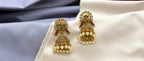 Kempu jhumka earrings featuring peacock motifs,dangling pearl beads Earrings