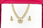 Matte finishing white stones with pearls and central green stone short Necklace