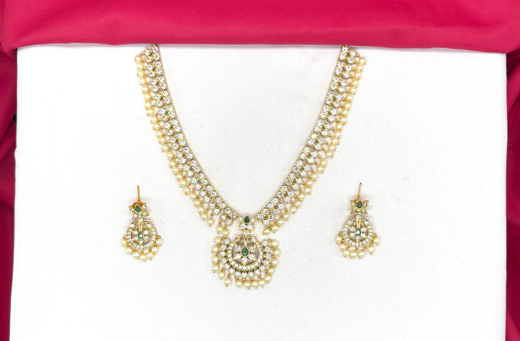Matte finishing white stones with pearls and central green stone short Necklace