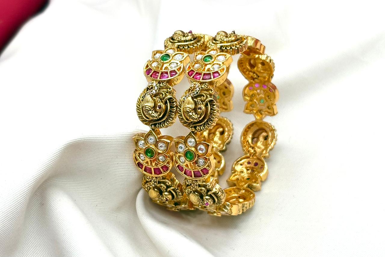Matte finishing peacock and floral motifs adorned with white,green and pink stones