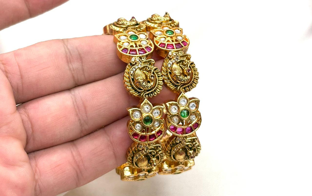 Matte finishing peacock and floral motifs adorned with white,green and pink stones
