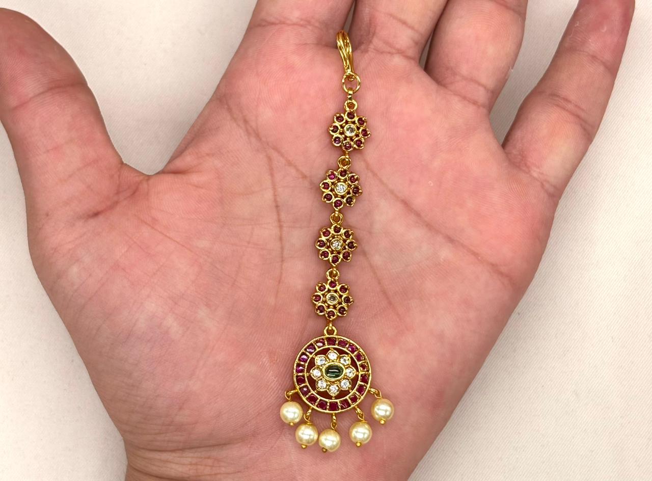 Ruby-colored and central green emerald stone pearl drop maang tikka