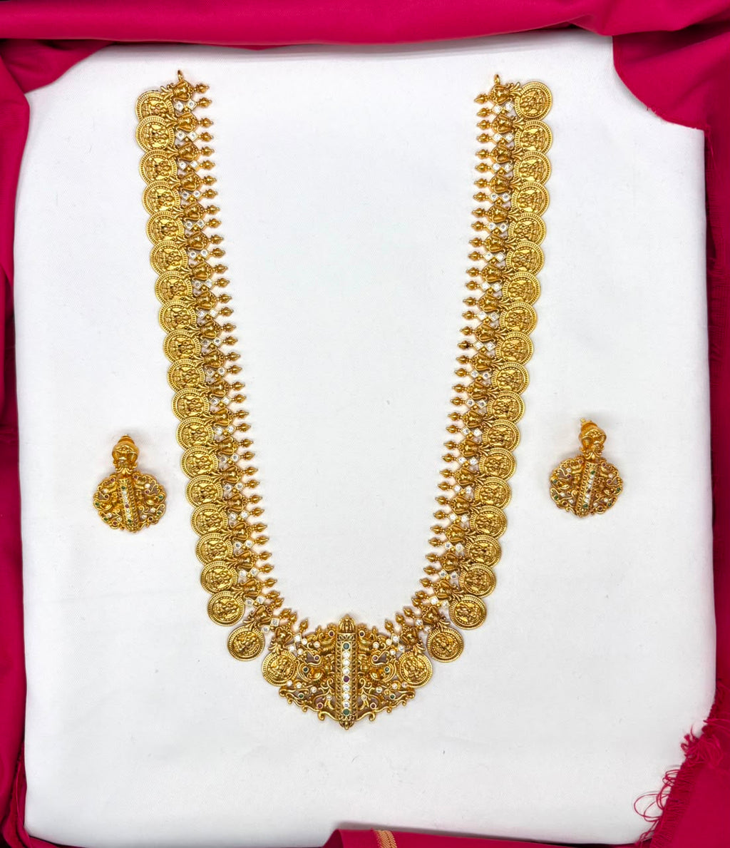 Matte finishing temple set features a long Lakshmi coin design haram necklace