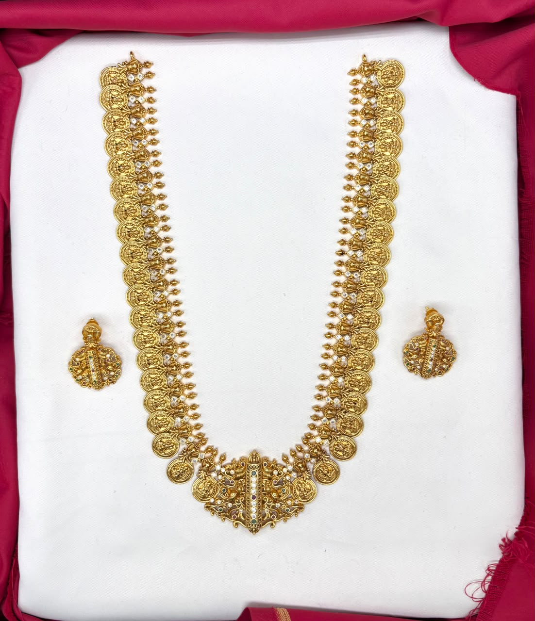 Matte finishing temple set features a long Lakshmi coin design haram necklace