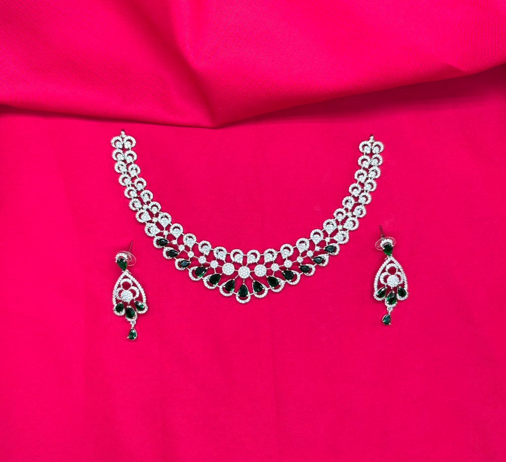 Silver finishing features a white rhodium plated zircon with green stones short necklace