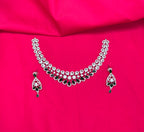 Silver finishing features a white rhodium plated zircon with green stones short necklace