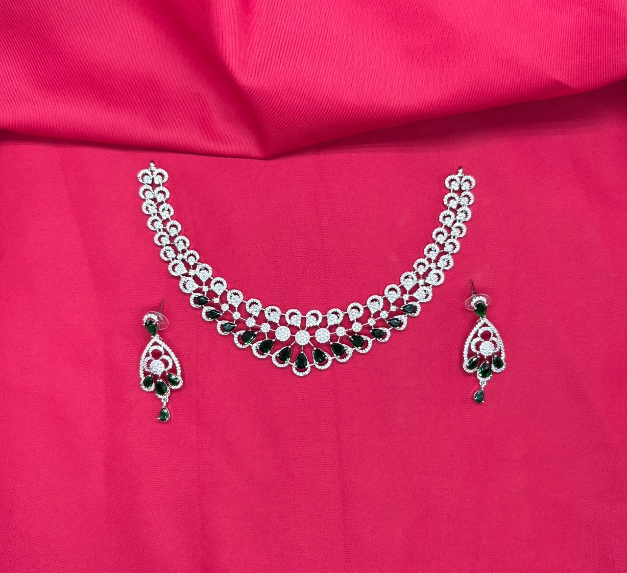 Silver finishing features a white rhodium plated zircon with green stones short necklace