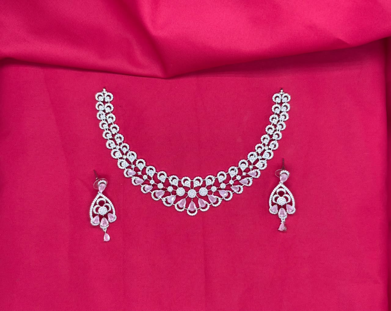 Silver finishing features white rhodium plated zircon with Baby-pink stones short Necklace