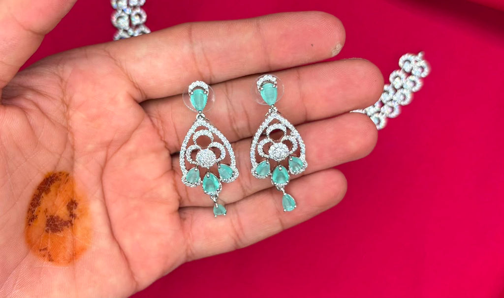 Silver finishing features white rhodium plated zircon withmint- green stones short Necklace