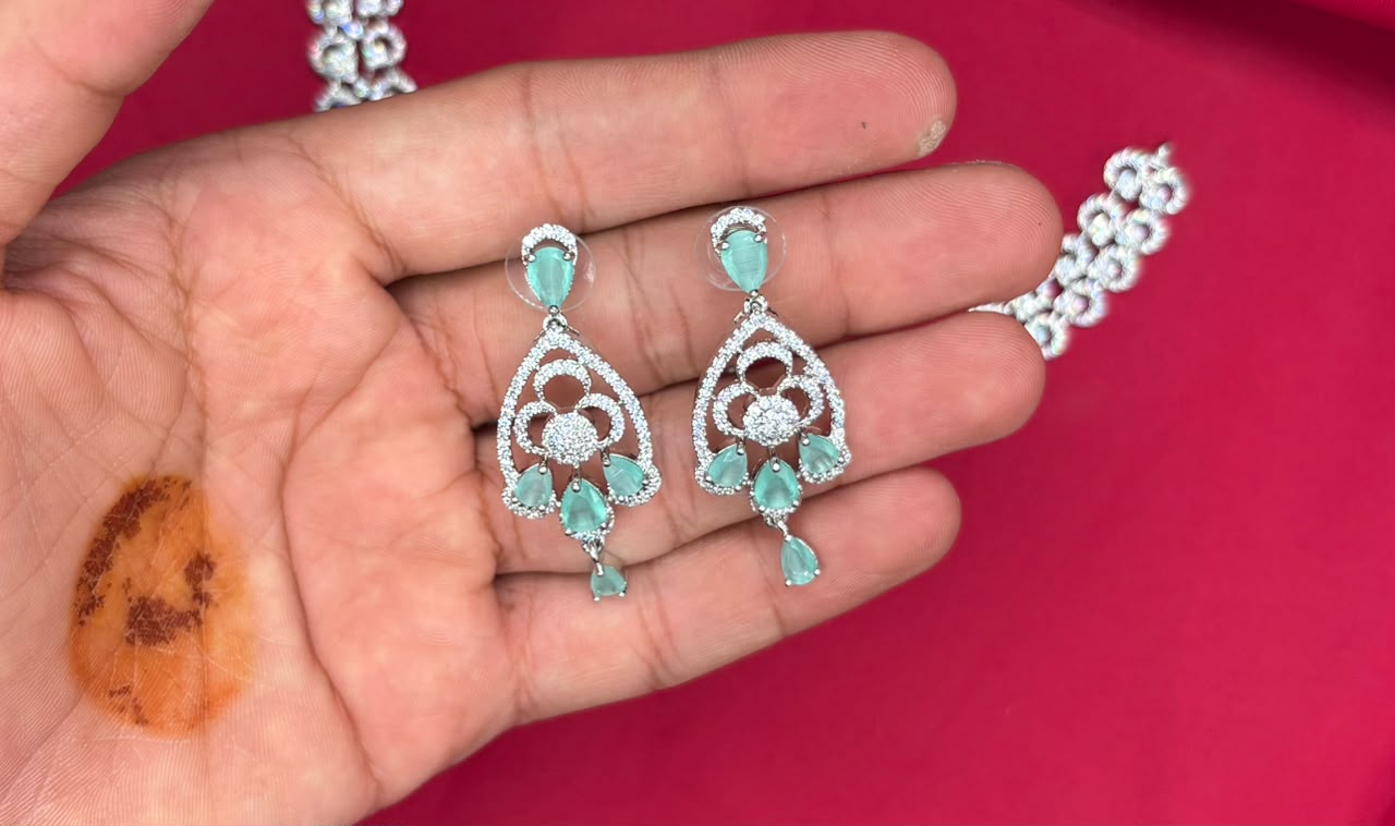 Silver finishing features white rhodium plated zircon withmint- green stones short Necklace
