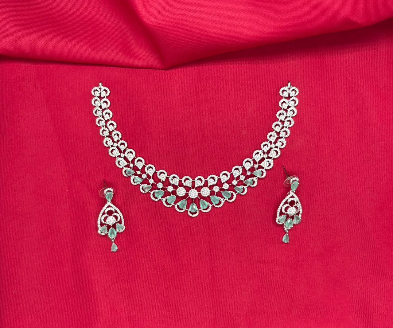 Silver finishing features white rhodium plated zircon withmint- green stones short Necklace