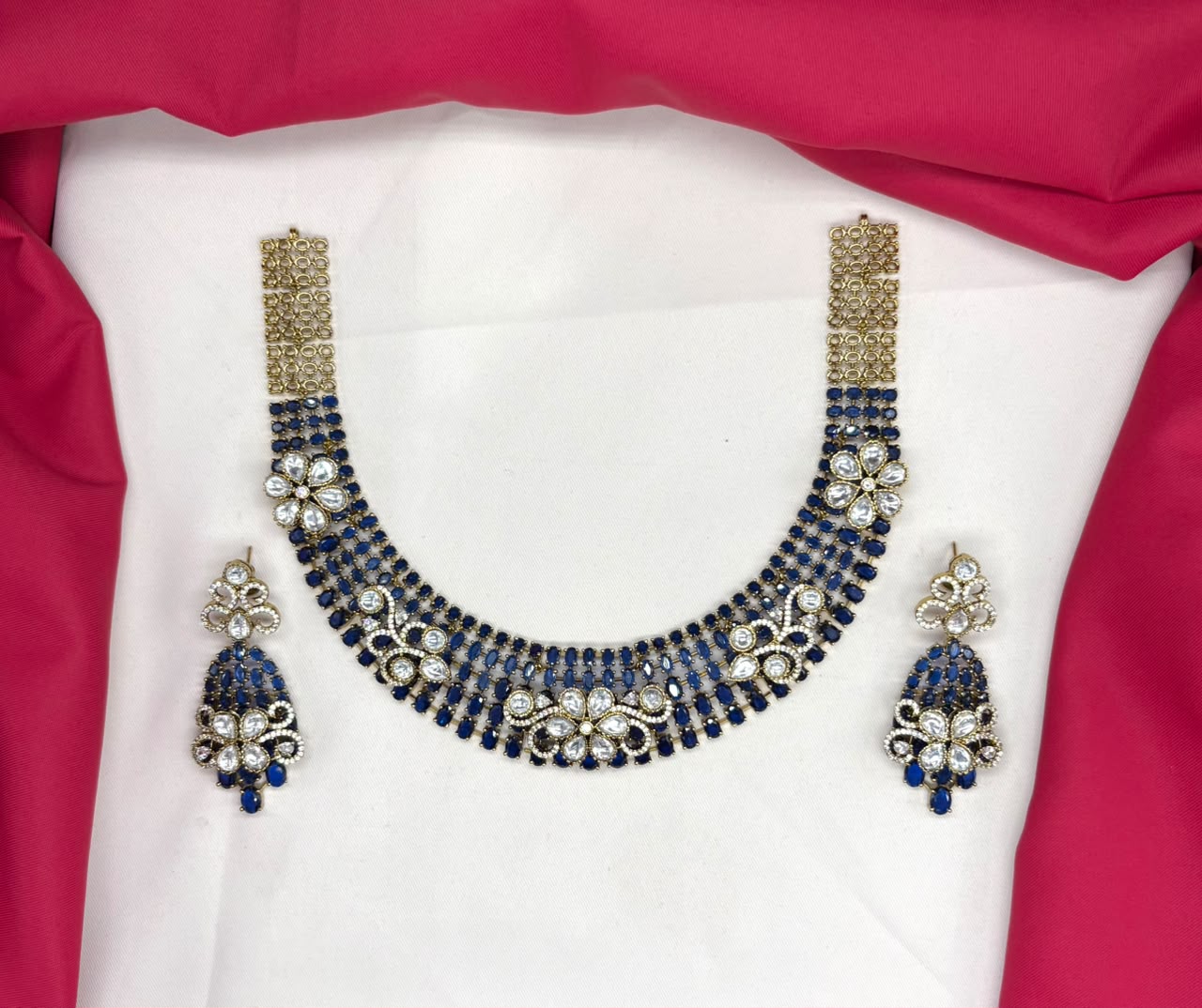 Victorian finish construction adorned with blue stones and floral-shaped white crystals Necklace