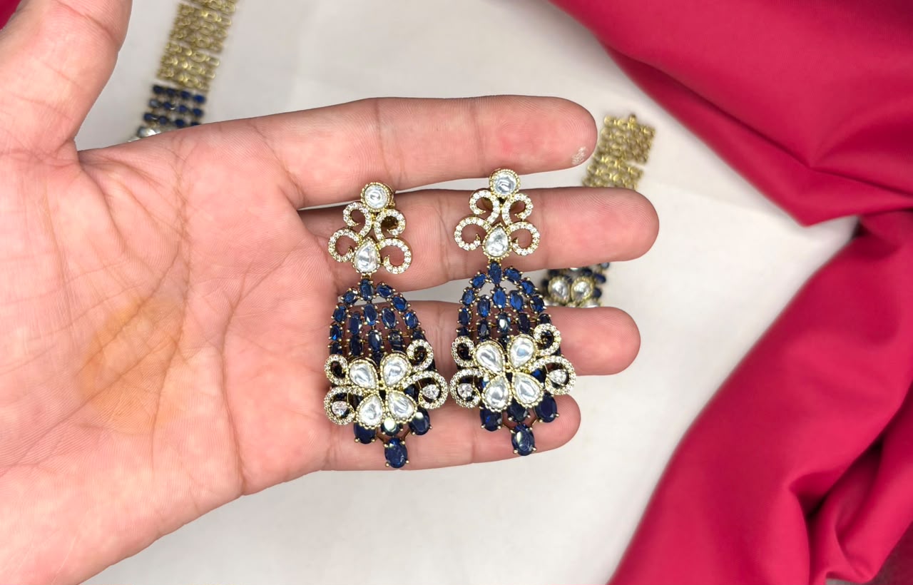 Victorian finish construction adorned with blue stones and floral-shaped white crystals Necklace