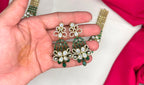 Victorian finish construction adorned with Green stones and floral-shaped white crystals Necklace