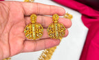 Matte finishing temple set features a long Lakshmi coin design haram necklace