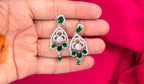 Silver finishing features a white rhodium plated zircon with green stones short necklace